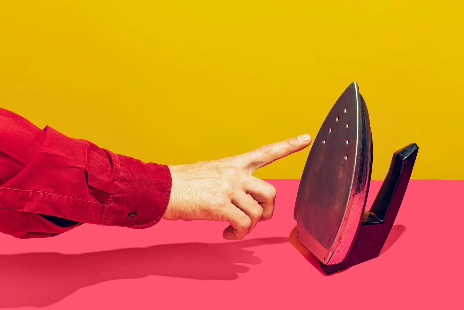 Hand going to poke an iron